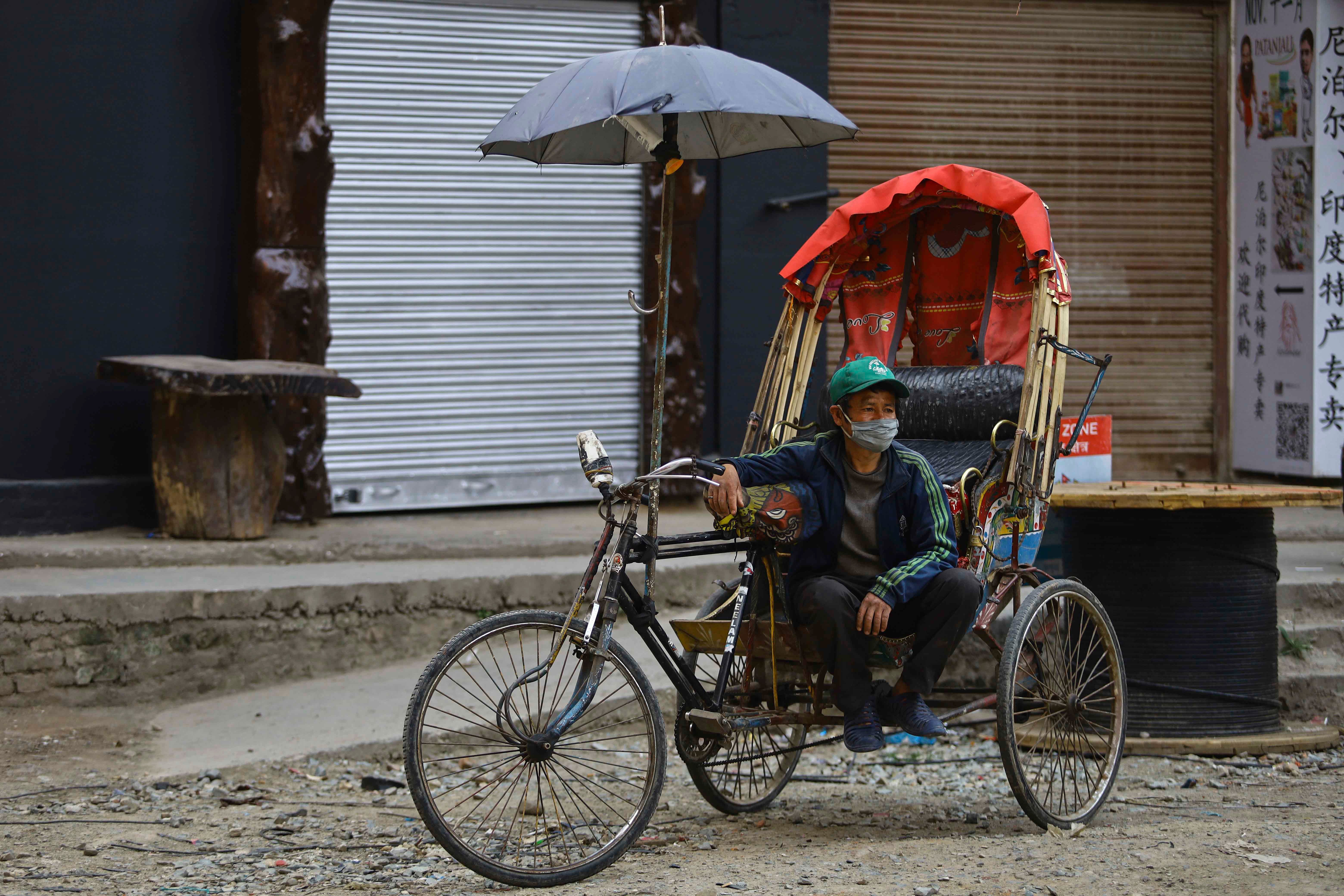 Rickshaw driver with mask on in Nepal 