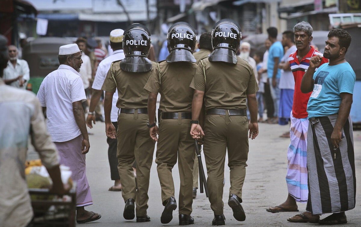 Sri Lankan police officers patrol a Muslim neighborhood after the Easter Sunday bombings, Colombo, April 26, 2019.