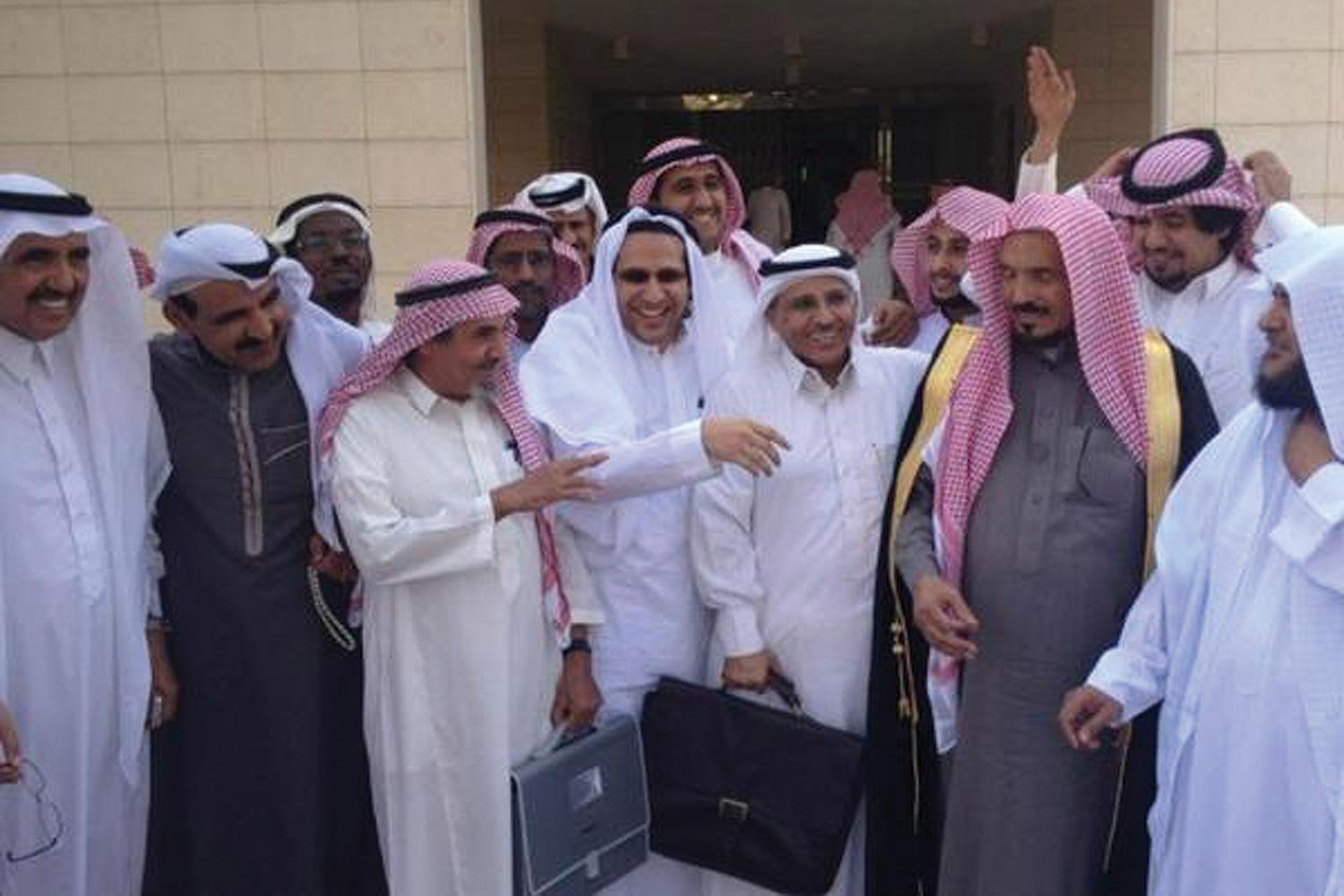 Saudi human rights activists gather outside the Criminal Court of Riyadh following a hearing in the trial of fellow activists Abdullah al-Hamid and Mohammed al-Qahtani. 