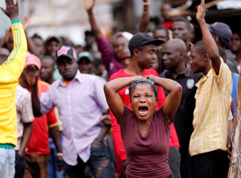A woman reacts near the dead body of a protester in Mathare, in Nairobi, Kenya August 9, 2017. REUTERS/Thomas Mukoya