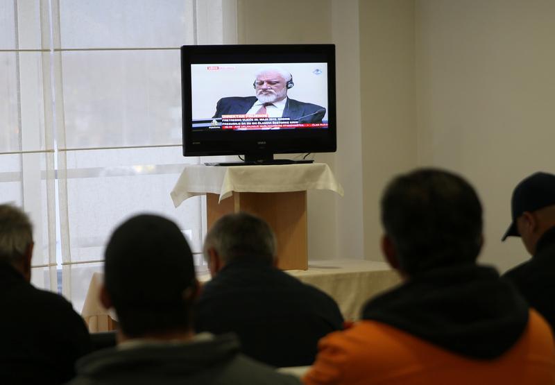 Slobodan Praljak is seen during television broadcast of the appeal trial in the Hague, Netherlands, for six Bosnian Croat senior wartime officials accused of war crimes against Muslims in Bosnia's 1992-1995 war, in Mostar, Bosnia and Herzegovina November 