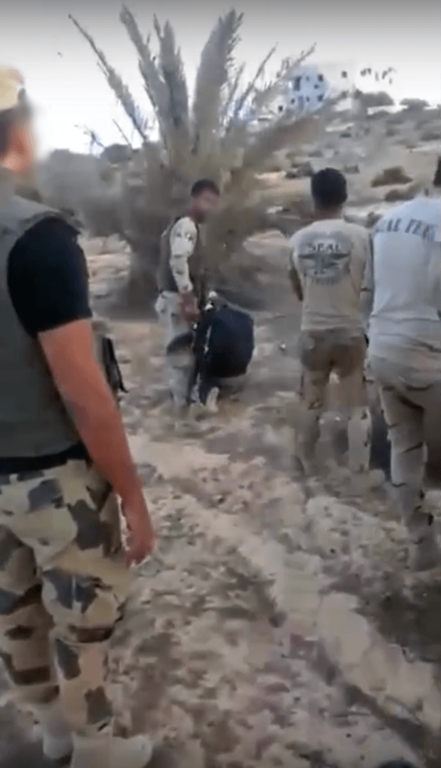 3) A member of a military-backed militia prepares to execute the second detainee. © 2017 Mekameleen