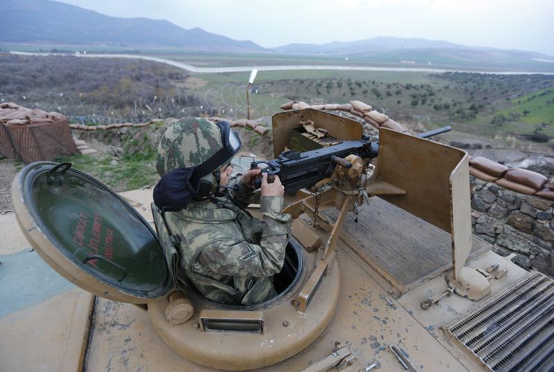 A Turkish soldier surveys the border line between Turkey and Syria near the city of Kilis, March 2, 2017. 