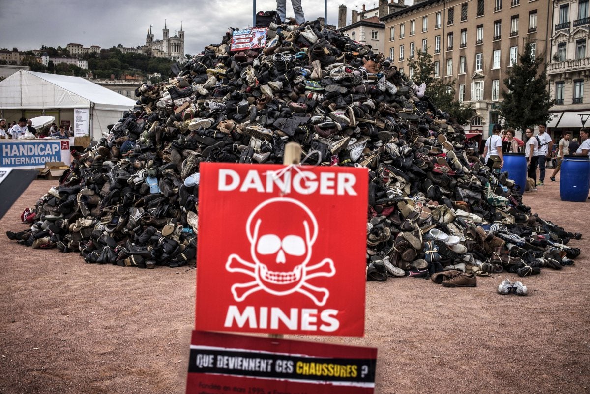 A pile of shoes during the annual demonstration by NGO Humanity and Inclusion denouncing antipersonnel landmines and cluster munitions in Lyon on September 20, 2014.
