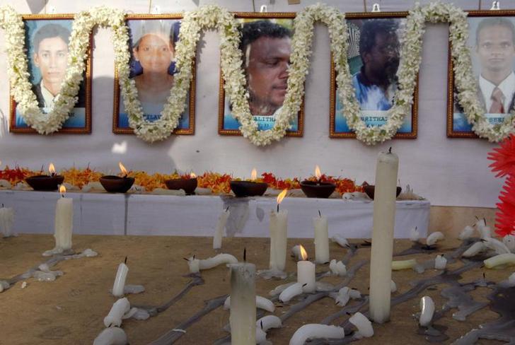 Candles are burned at the memorial for slain humanitarian workers from Action Contre La Faim in Batticaloa, Sri Lanka, August 11, 2006.
