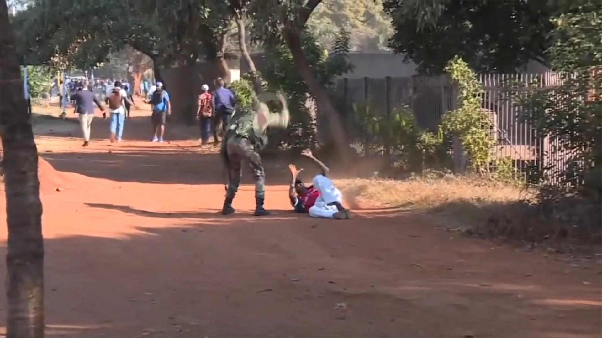 A man is beaten by a Zimbabwean soldier after protests broke out across the country on January 14, 2019.