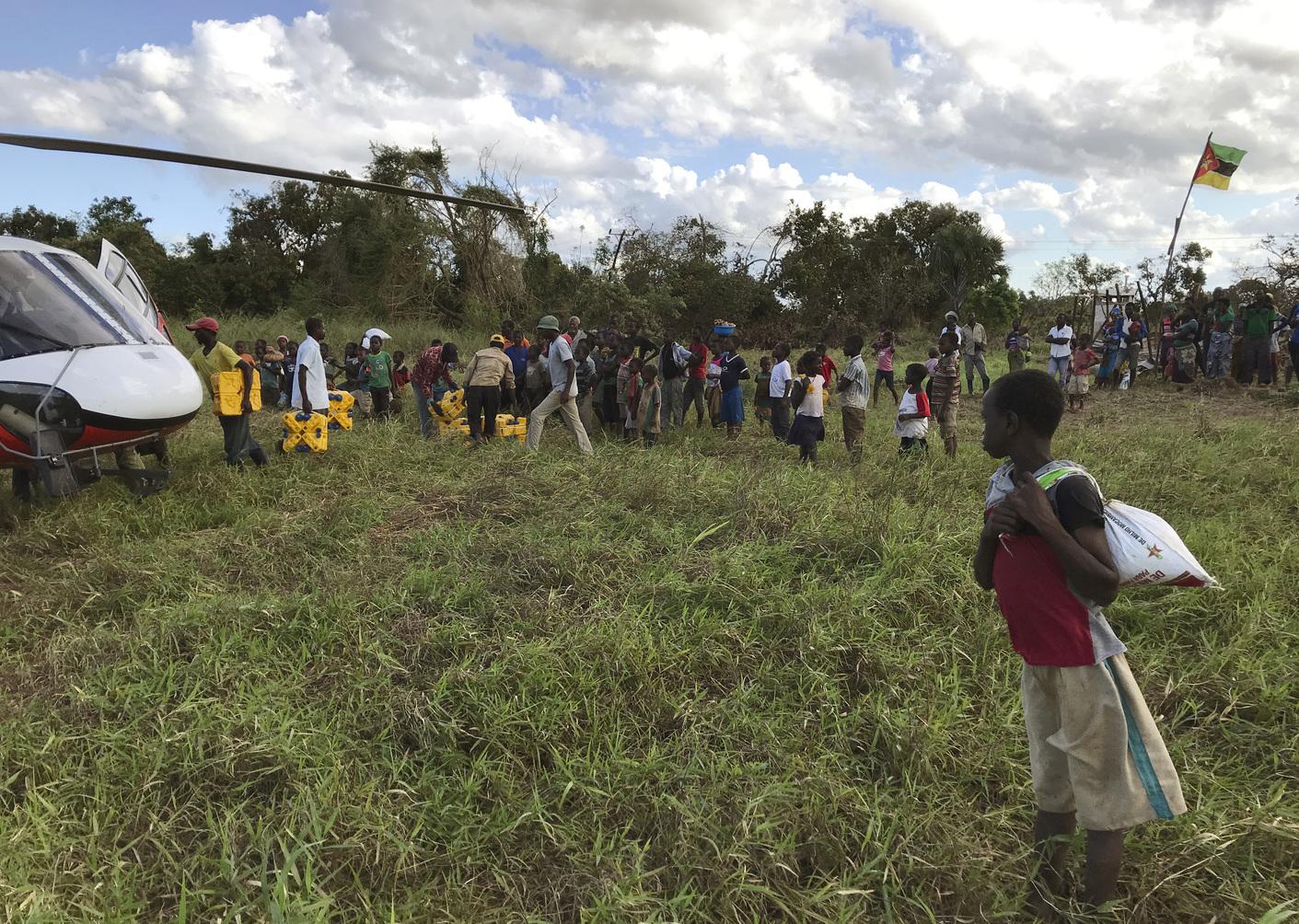 A boy watches the distribution of aid in the remote village of Bopira, Mozambique, April 6, 2019. © 2019 AP Photo/Cara Anna)