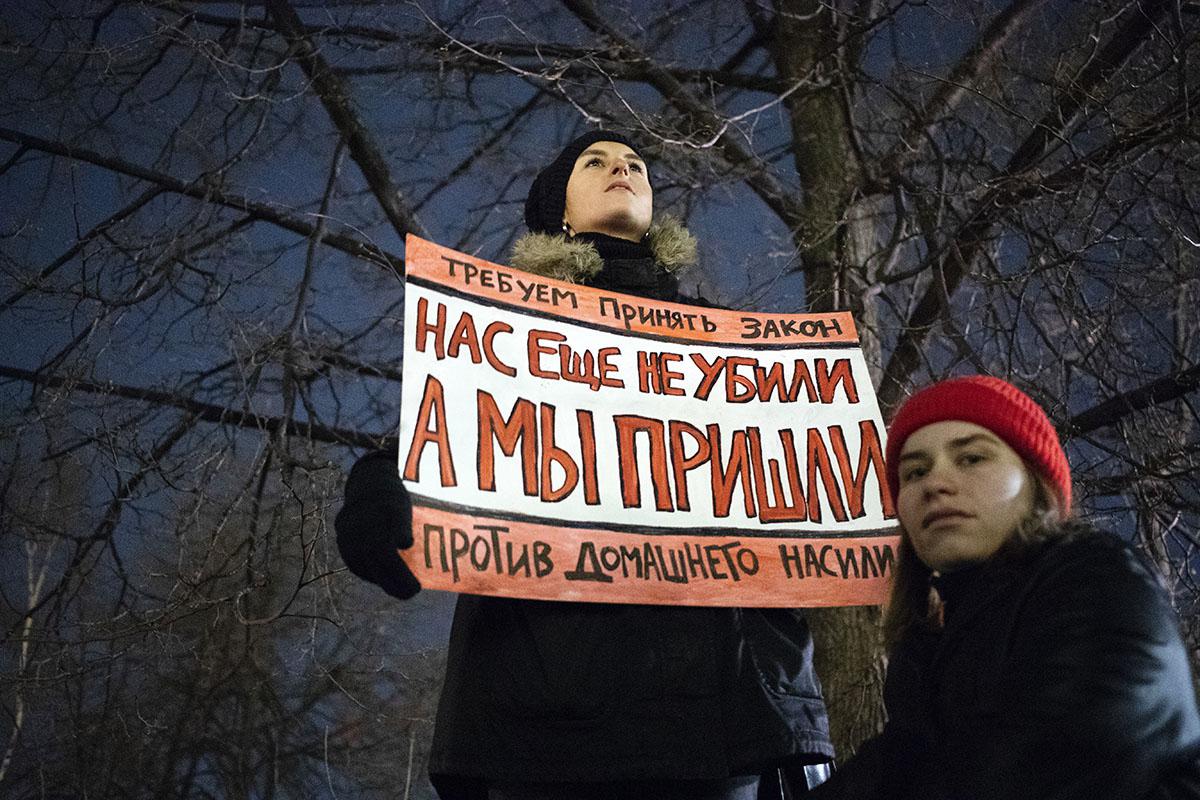 At a Moscow rally in support of domestic violence legislation, a woman holds a banner that reads "We demand a law against domestic violence. We are not killed yet, but we're close", Monday, Nov. 25, 2019.