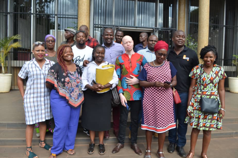 The seven activists, lawyer Jessie Majome (with yellow folder), family and friends outside Rotten Row Magistrates Court on January 8, 2020.