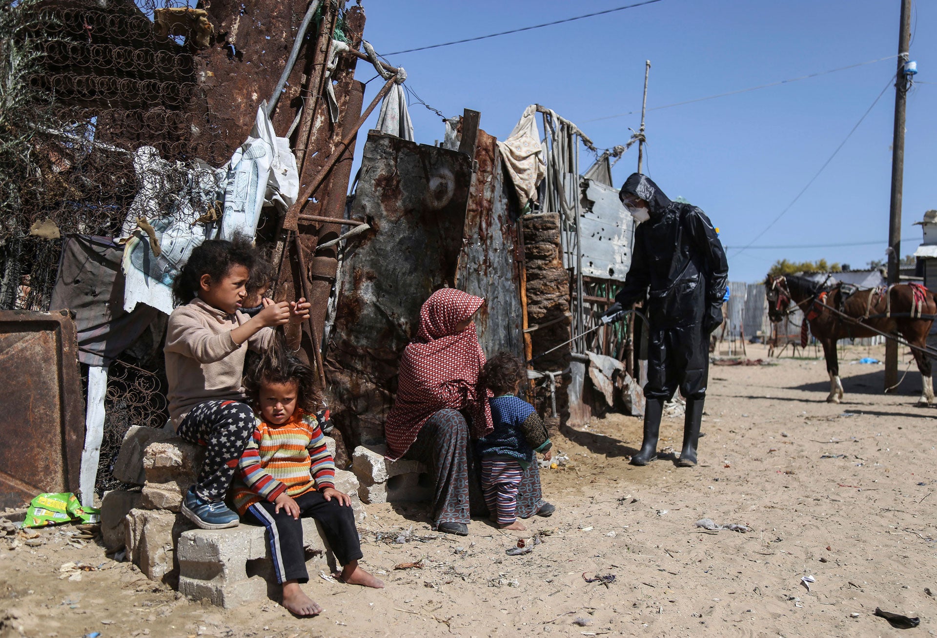 Palestinian workers spray disinfectant at Nahr al-Bared camp to prevent against the spread of coronavirus in Khan Yunis, southern Gaza Strip, Palestine, March 29, 2020.