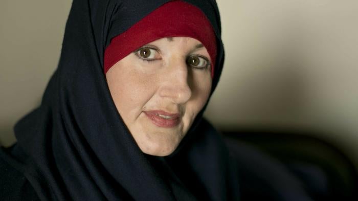 A woman poses wearing a hijab