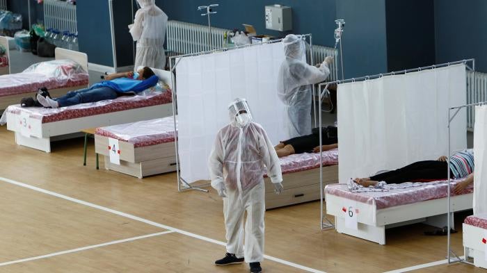 Medical specialists wearing personal protective equipment (PPE) treat patients at a day hospital, which is located in a school gym and provides services free of charge, in Bishkek, Kyrgyzstan July 16, 2020.