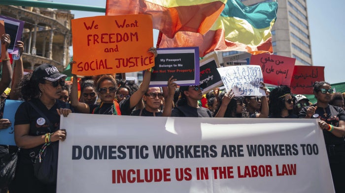 Protestors holding banners calling for the abolishment of Lebanon's controversial kafala sponsorship system.