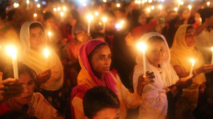 A crowd of women holding candles