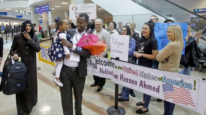 Abdisellam Hassen Ahmed, a Somali refugee who had been stuck in limbo after President Donald Trump temporarily banned refugee entries, walks with his wife Nimo Hashi, and his 2-year-old daughter, Taslim, who he met for the first time after arriving at Salt Lake City International Airport, February 10, 2017.