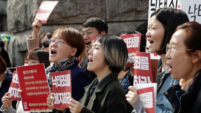 Protesters celebrate after listening to a judgment during a rally demanding the abolition of abortion law outside of the Constitutional Court in Seoul, South Korea, April 11, 2019.