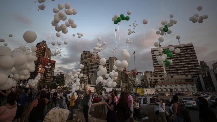 Lebanese people release balloons bearing the names of the victims of the 4 August Beirut seaport blast to mark the two-month anniversary of the explosion that killed 200 people and injured more than 6,500 others.