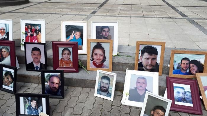 Photos of Syrians who have been detained or disappeared set up by Families for Freedom, as part of a protest in front of the court in Koblenz, July 2, 2020. 
