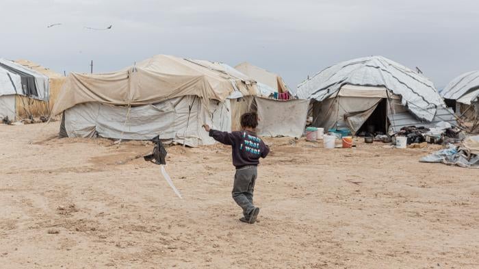 A boy flies a home-made kite in the foreigners’ section of al-Hol camp in northeast Syria on March 15, 2021.