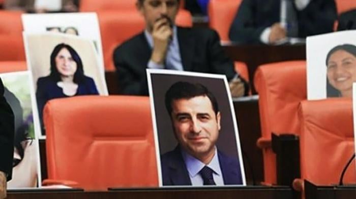 Selahattin Demirtaş, former co-chair of the Peoples’ Democratic Party (HDP), was among MPs jailed on November 4, 2016. His vacant seat in the general assembly of Turkey’s parliament is shown here marked with his photo.