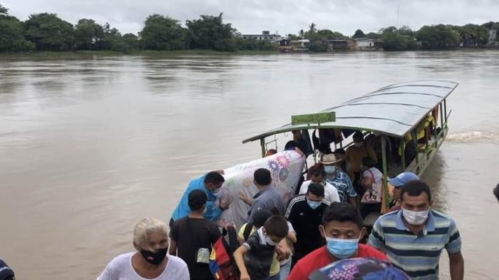 People disembark in Colombia after fleeing Venezuela's Apure state due to a Venezuelan military operation against armed groups in the region, as well as egregious abuses by Venezuelan security forces.