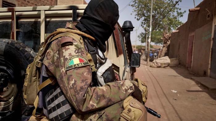A member of the Malian Armed Forces (FAMA) patrols a road in central Mali, February 2020.