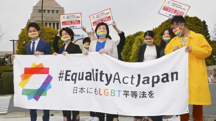 Supporters of Equality Act Japan gather in front of parliament before they submit a petition in Tokyo on March 25, 2021. 