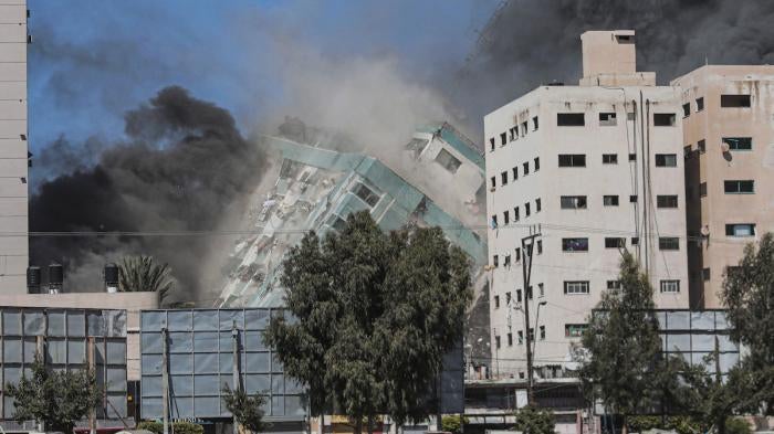 The Jala Tower as it is destroyed in an Israeli airstrike in Gaza. Israel's air force targeted the 13-floor Jala Tower housing Qatar-based Al-Jazeera television and the Associated Press news agency.