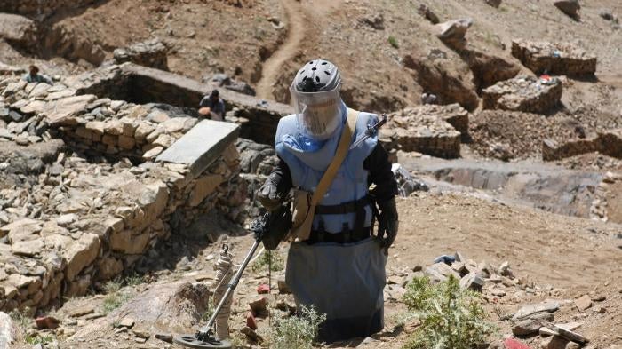 Clearance operator from the Halo Trust clearing a steep, rocky hillside in Afghanistan.