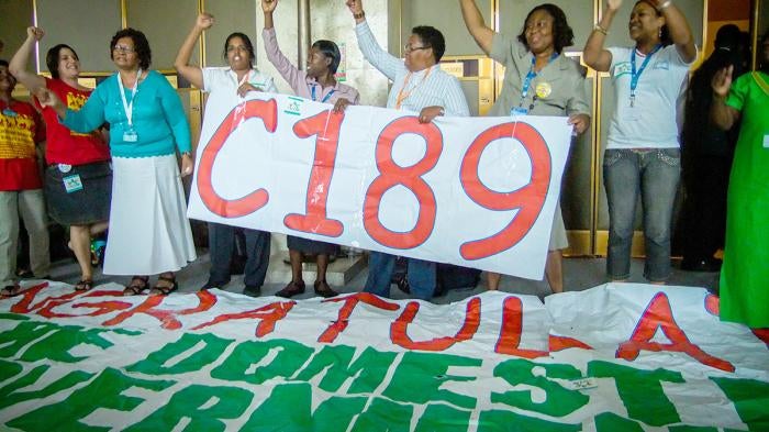 Domestic worker leaders chant “Up up domestic workers, down down with slavery” after the ILO vote to adopt the Domestic Workers Convention, June 16, 2011
