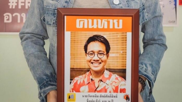 Sitanun Satsaksit holds a portrait of her brother, Wanchalearm, who was forcibly disappeared while living in exile in Cambodia on June 4, 2020. 