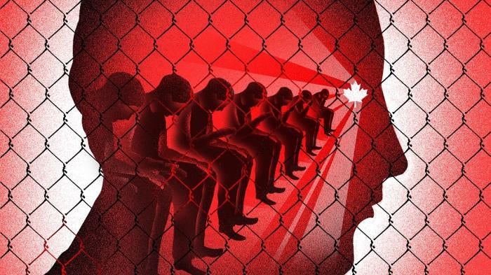 Image in shades of red with a fence in front of seated people.