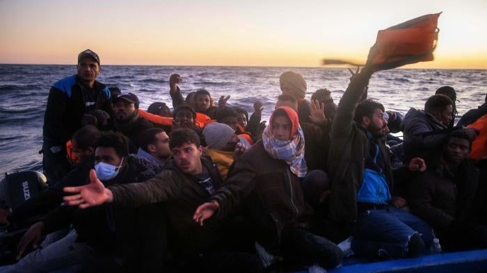 Migrants and refugees on an overcrowded rubber boat during a rescue by the Spanish NGO Open Arms in the Mediterranean Sea, Feb. 12, 2021