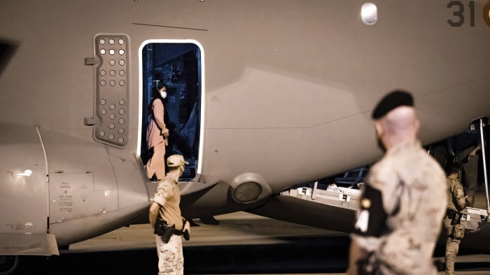 Afghan families get off the Spanish military plane at the Torrejón de Ardoz military base in Madrid. The flight that left Kabul was carrying five Spaniards and 48 Afghan refugees, including 10 minors. 