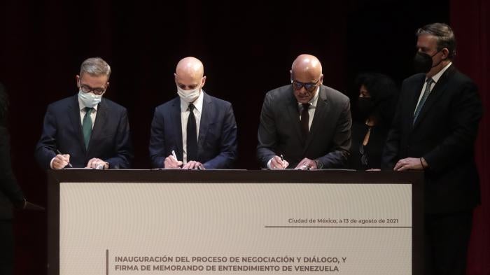 Head of the Venezuelan opposition delegation Gerardo Blyde, Kingdom of Norway representative Dag Nylander, Venezuelan National Assembly President Jorge Rodríguez, and Mexican Foreign Affairs Minister Marcelo Ebrard during the Inauguration of the Negotiation and Dialogue Process and Signature of the Memorandum of Understanding of Venezuela, at the National Museum of Anthropology on August 13, 2021, in Mexico City.