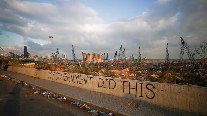 Graffiti on a wall that reads "My Government Did This"
