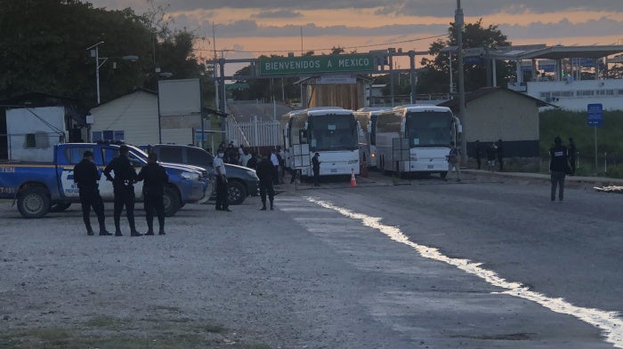 Buses sit on the Mexican side of the El Ceibo border crossing after having expelled migrants into Guatemala.