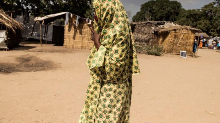 A woman walks through the Internally Displaced Person camp "25 de junho," in Metuge, Mozambique on May 20, 2021. 
