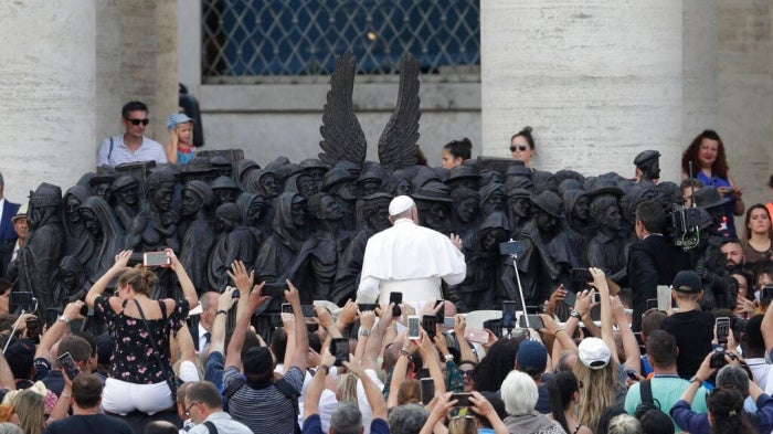 Pope Francis unveils the sculpture on the theme of refugees and migration ' Angels Unawares ' by Canadian sculptor Timothy P. Schmalz, on Migrant and Refugee World Day, in St. Peter's Square, at the Vatican, Sunday, Sept. 29, 2019.