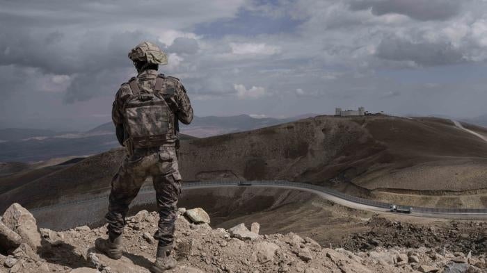 A Turkish soldier stands at the Turkish border with Iran
