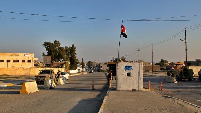 Iraqi soldiers stand guard at a checkpoint in Nineveh, Iraq. Friday Dec. 4, 2020.