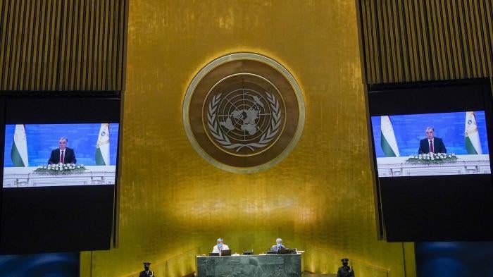 A man on two video screens in the UN general assembly hall