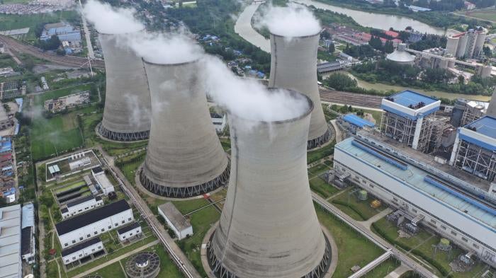 Steam billows out of the cooling towers of a coal-fired power plant in Huai'an in east China's Jiangsu province, July 20, 2021.
