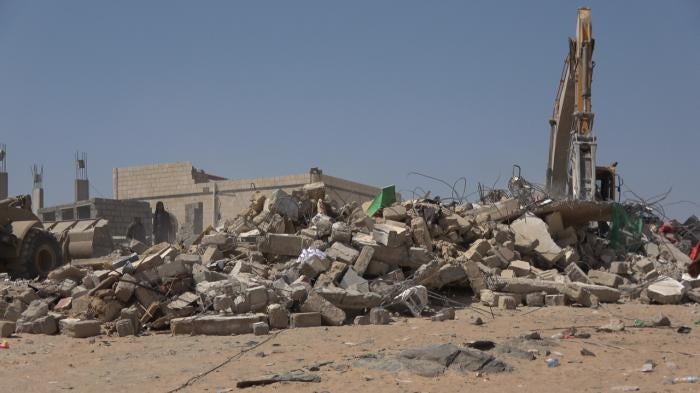 A truck searches for victims under the rubble. The house was destroyed by a Houthi missile in Al-Amoud in al-Jubah district, Marib governorate pictured on October 29, 2021.  