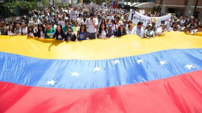 People holding Venezuelan flag