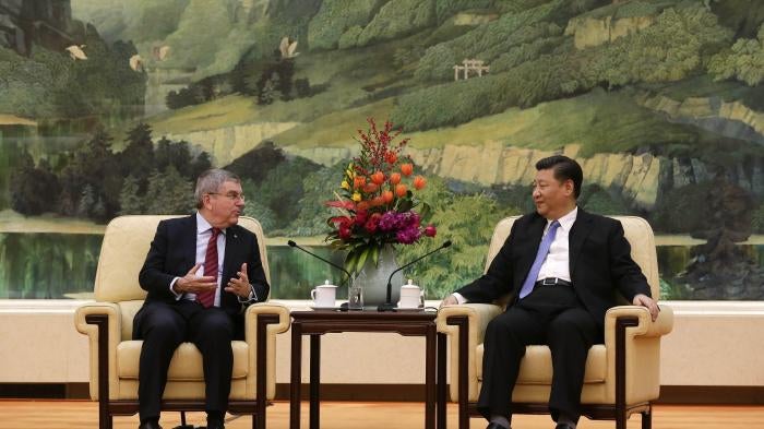 Two men speak to each other while seated