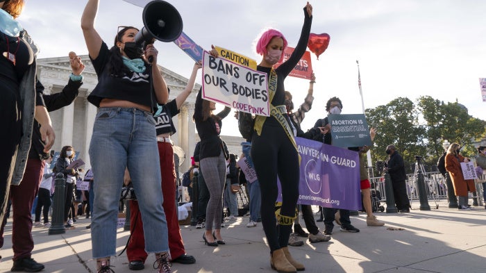 Women holding protest signs