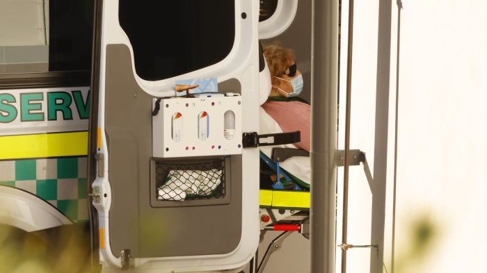 A woman in the back of an ambulance