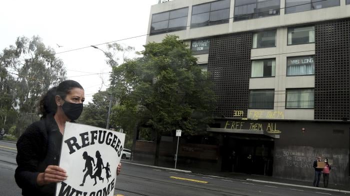 A protester outside the Park Hotel calling for the release of refugees being detained inside the hotel in Melbourne