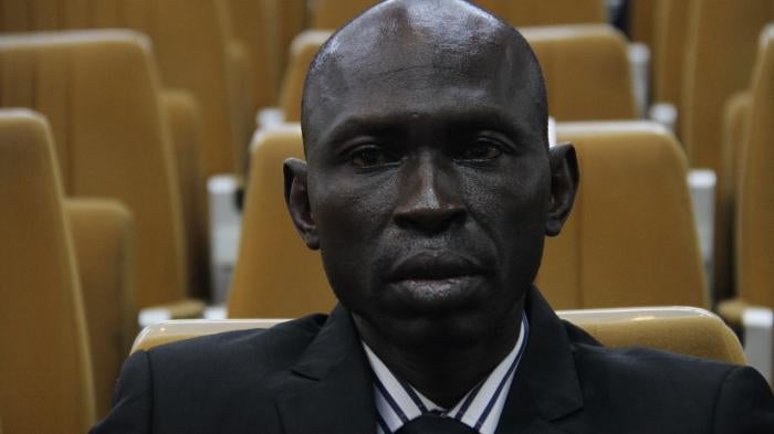 A man sits facing the camera